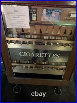 A vintage cigarette dispenser in good condition